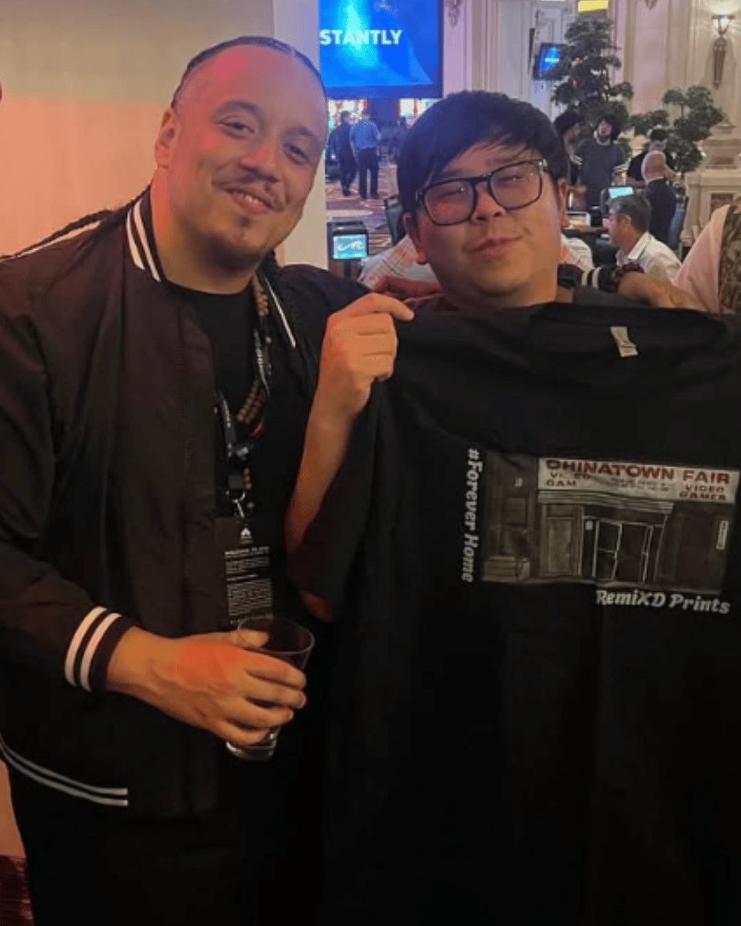 Image of IFC Yipes and Justin Wong together. Justin is holding up the 